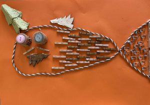 Praca zatytułowana – Ryba, wykonana głównie z drobnych drewnianych i metalowych elementów