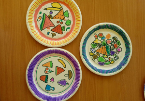 Przykładowe prace uczniów przedstawiające papierowe talerze z rysunkami owoców i warzyw
