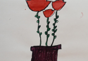 Laurka wykonana przez ucznia uczęszczającego do świetlicy szkolnej. Przedstawia trzy czerwone róże w brązowym pojemniku.