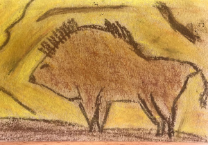 Na jasnej tekturce widoczny bizon. Tło pomarańczowo-żółte